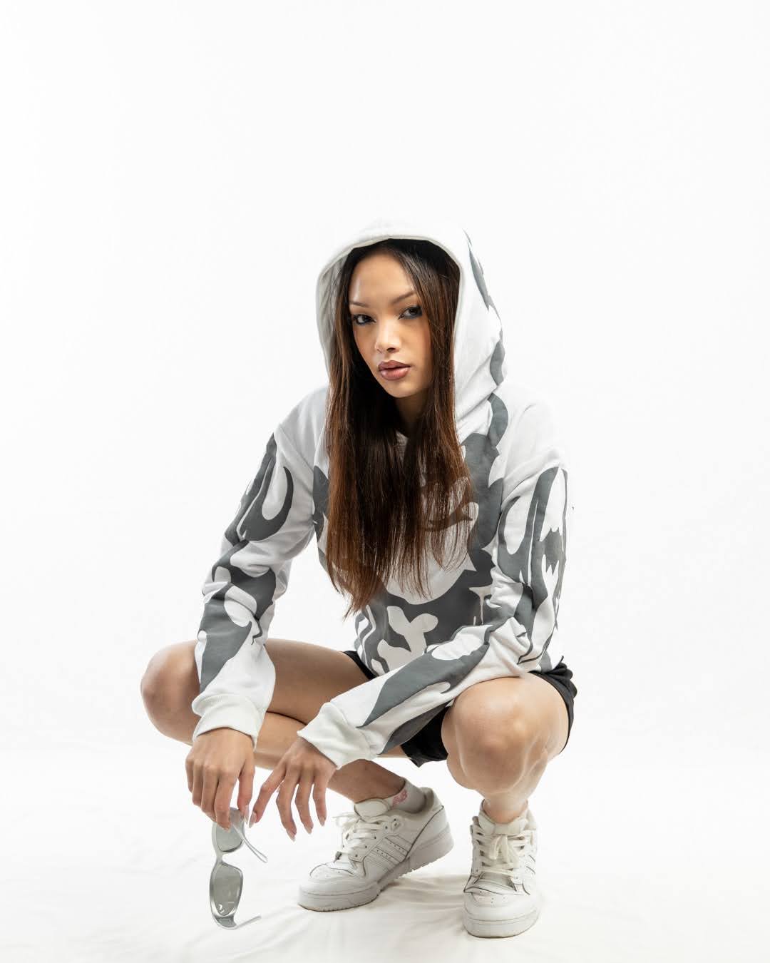 Close-up of the tactile 3D raised puff print graphic on the premium white fleece Exotix streetwear hoodie