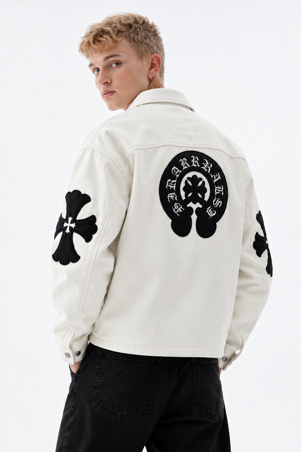Back view of male model in the white Exotix jacket displaying the massive black leather horseshoe emblem and sleeve cross appliqués