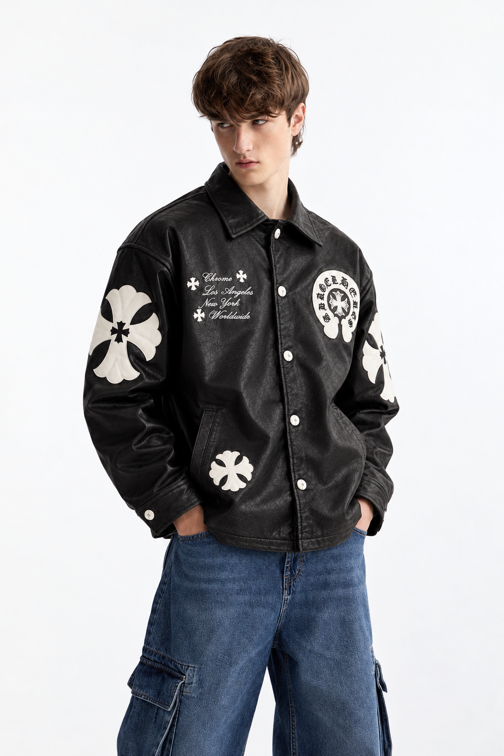 Male model wearing the Obsidian Black Gothic cross patch faux leather jacket by Exotix, highlighting the monochrome dark luxury aesthetic
