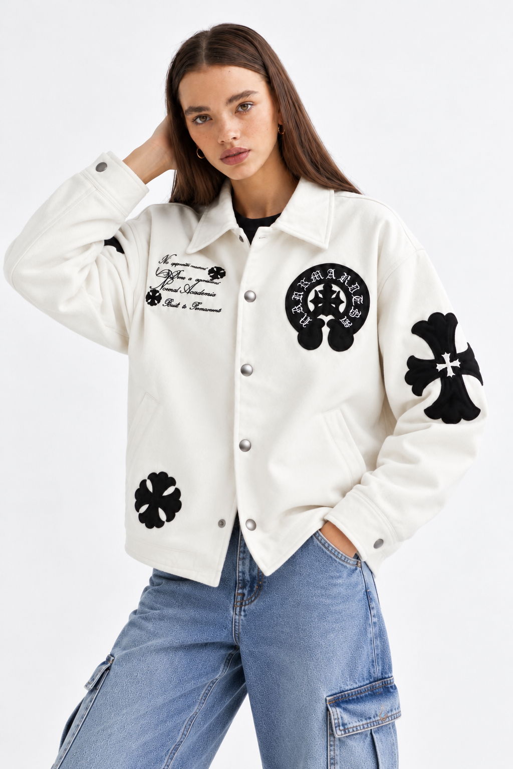 Female model wearing the unisex Chalk White Gothic cross patch faux leather jacket, demonstrating the modern boxy streetwear drape