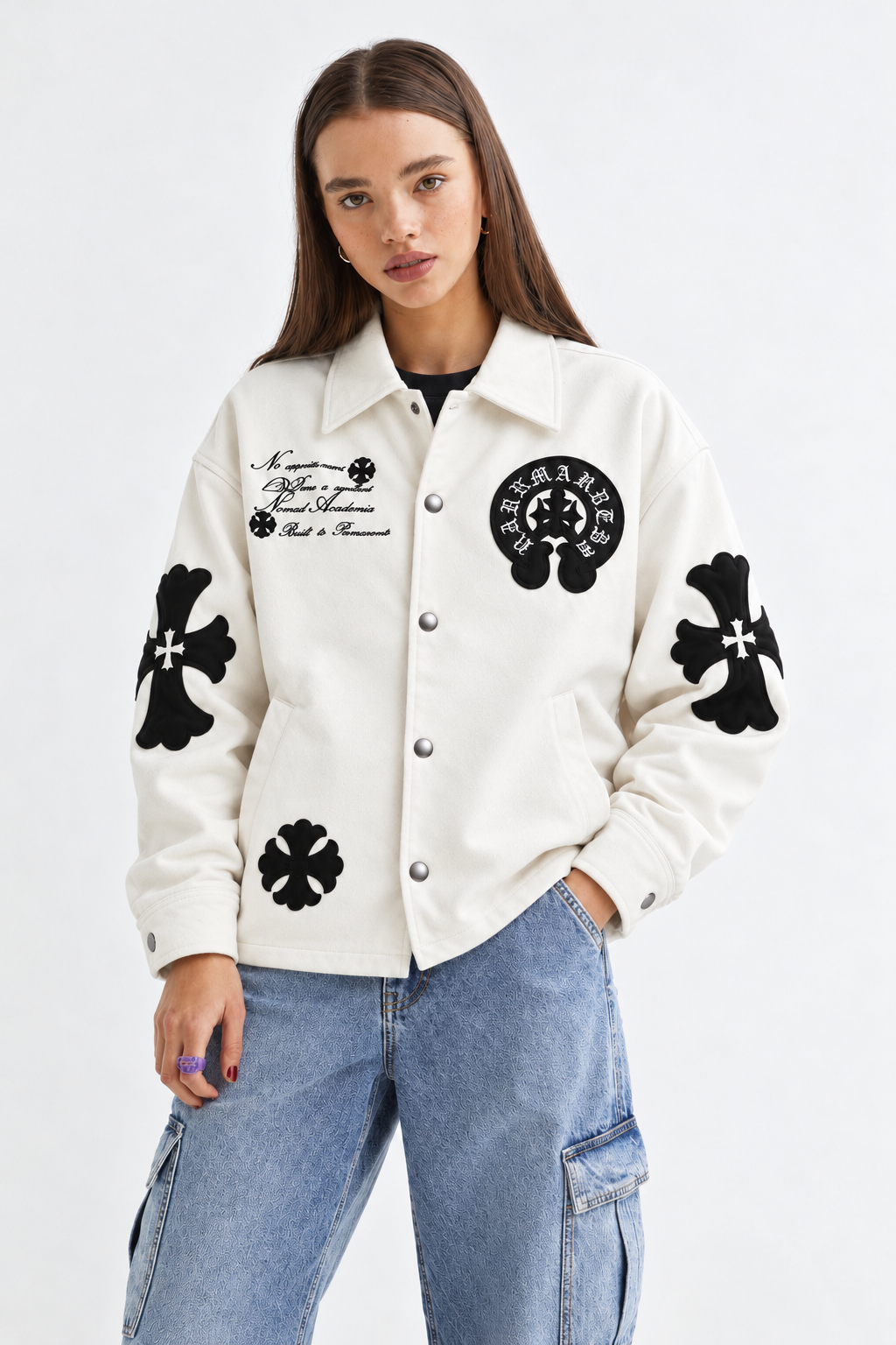 Full lifestyle street shot of a girl styling the cream cross patch leather jacket with camouflage pants