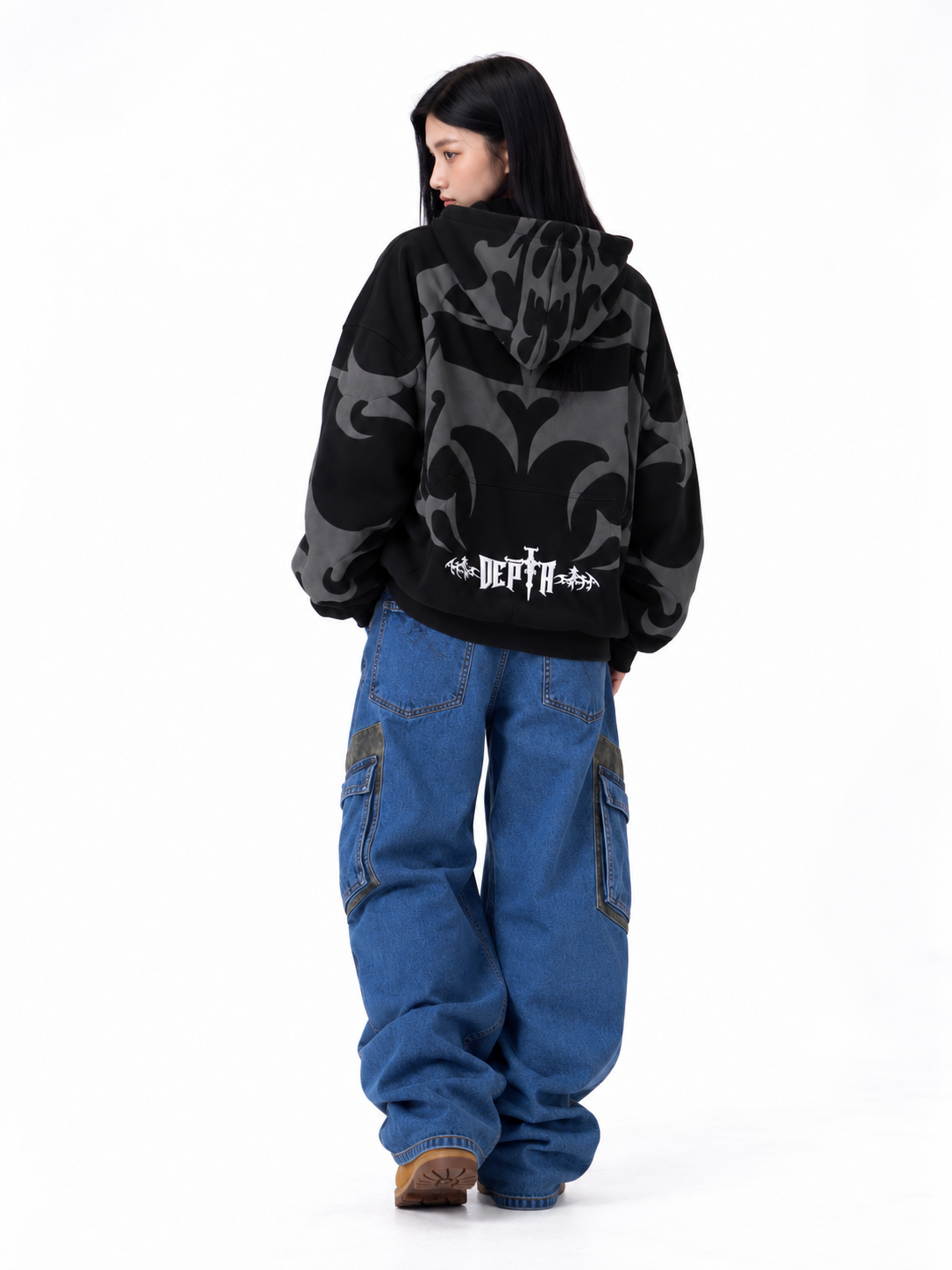 Lifestyle shot of the girl styling the black tribal shadow hoodie, highlighting the cozy oversized streetwear drape