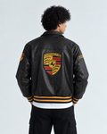 Back view of the male model wearing the Exotix black motorsport leather jacket, emphasizing the large 100% threadwork Porsche embroidery