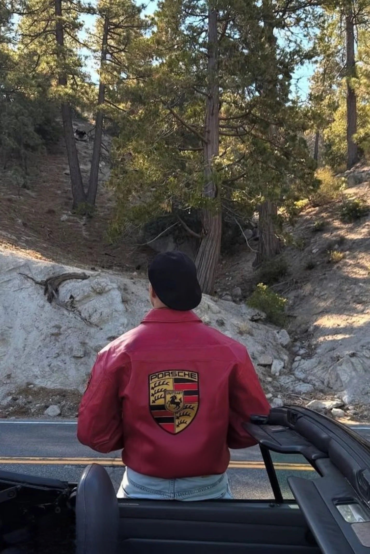 Male model wearing the Exotix Red Porsche 993 Leather Jacket, showcasing the modern cropped fit and F1 racing aesthetic
