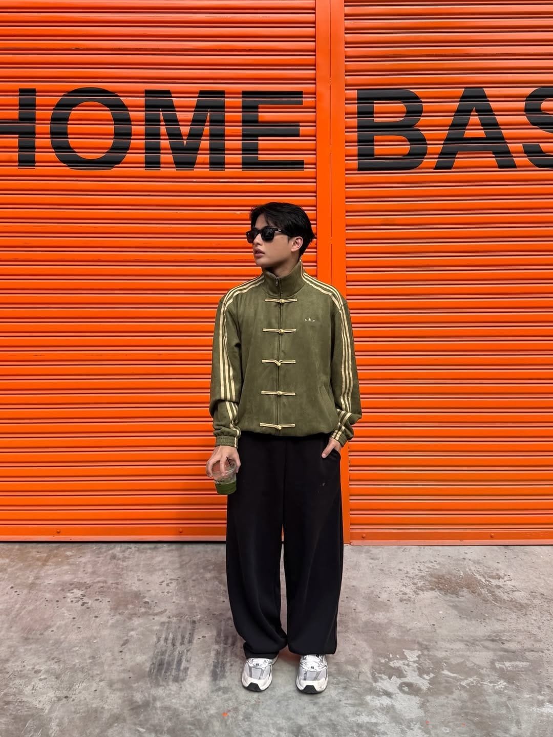 Male model in the earthy Olive Green oversized Asian streetwear jacket.