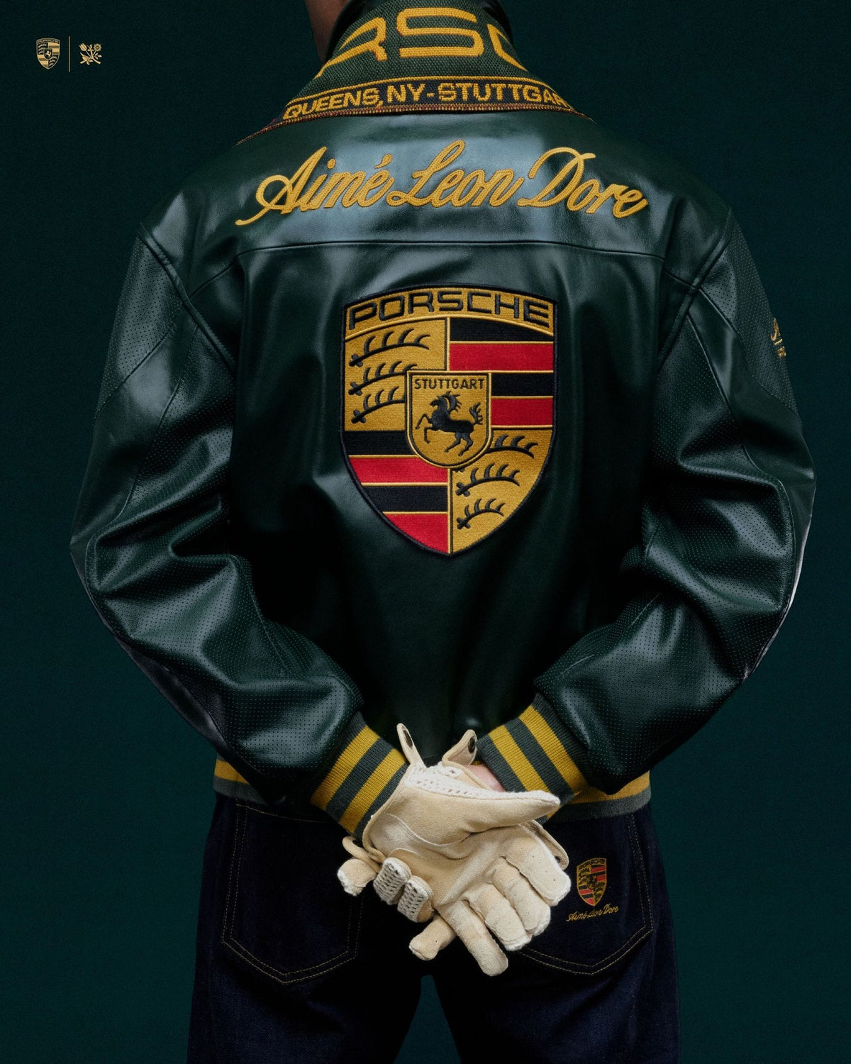 Detailed close-up shot of the high-density threadwork embroidery and vintage racing patches on the green faux leather shell