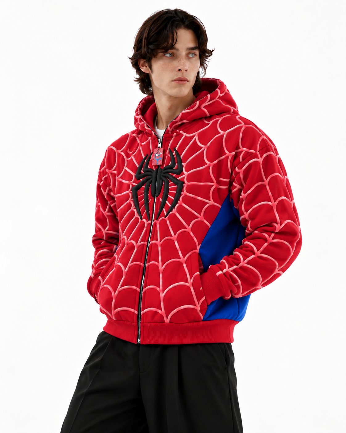 Close up of a man wearing the red heavyweight fleece Spidey hoodie, highlighting the 3D puff print artwork and split kangaroo pocket
