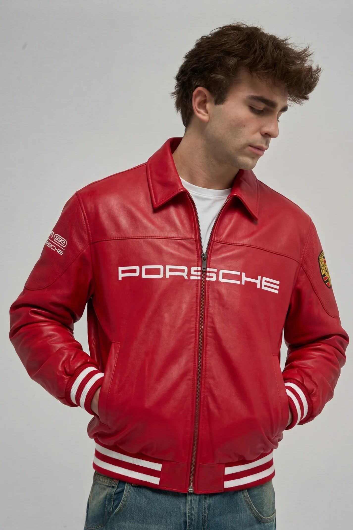 Urban streetwear lifestyle shot highlighting the Y2K racing aesthetic of the cropped red F1 leather jacket