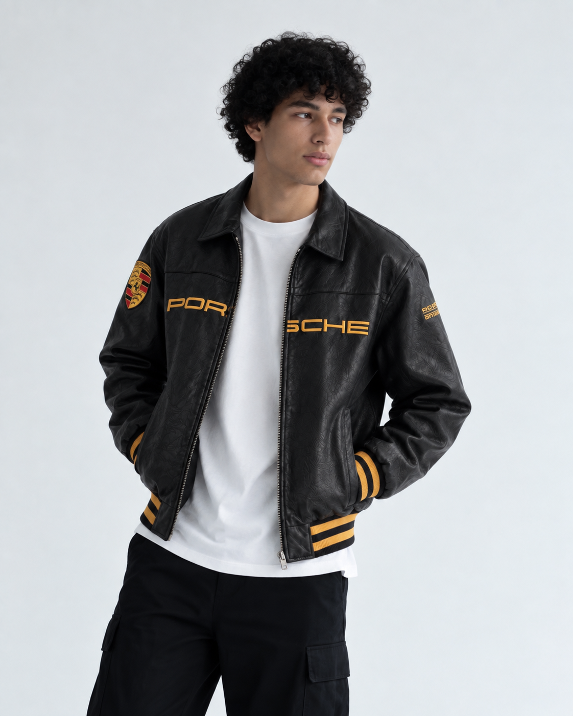 Male model styling the premium PU leather Porsche 993 jacket, showcasing the front kangaroo pockets and heavy-duty zipper