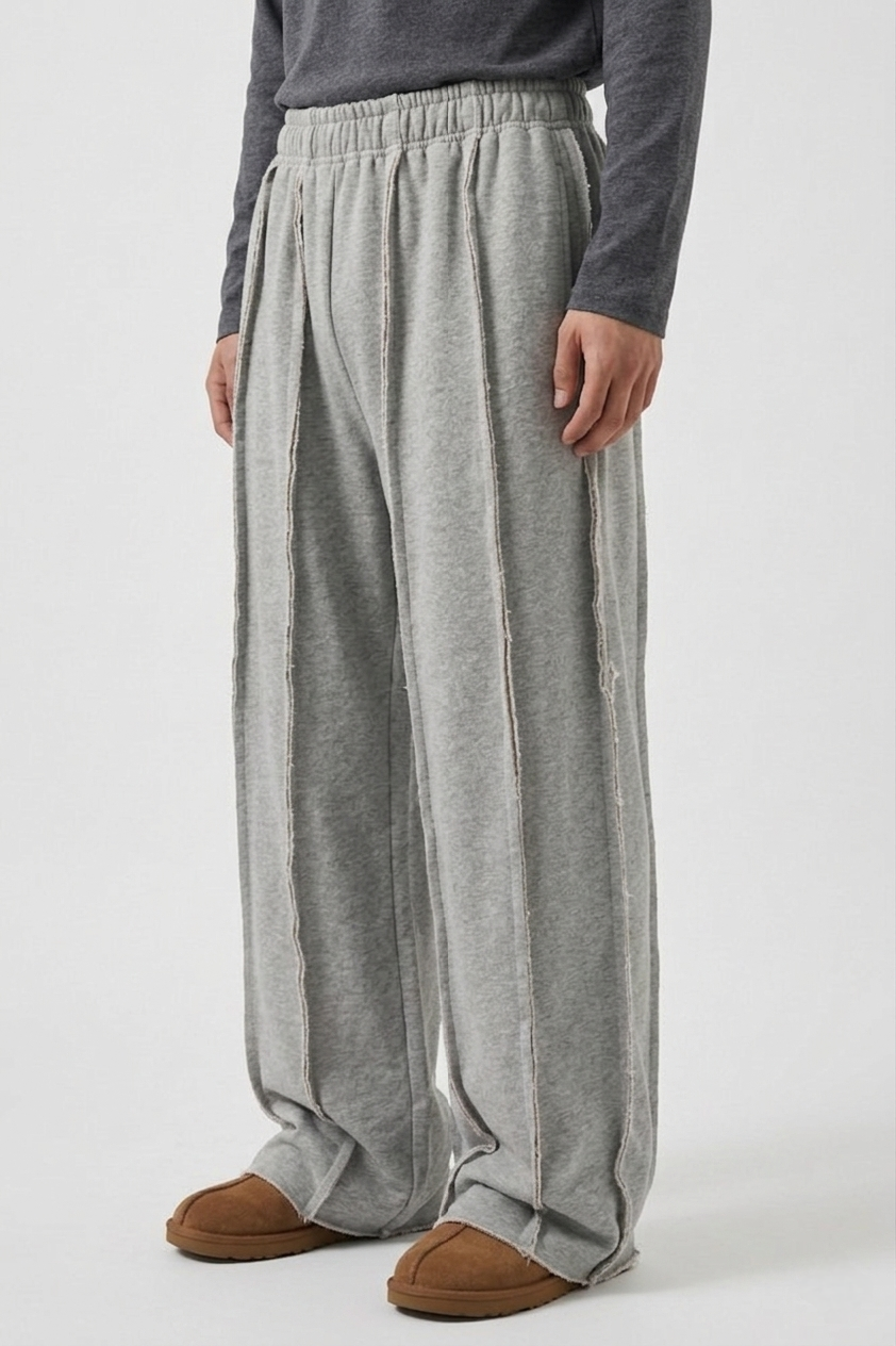 Close-up detail of the deconstructed exposed seams on the premium heavyweight fleece men's streetwear joggers