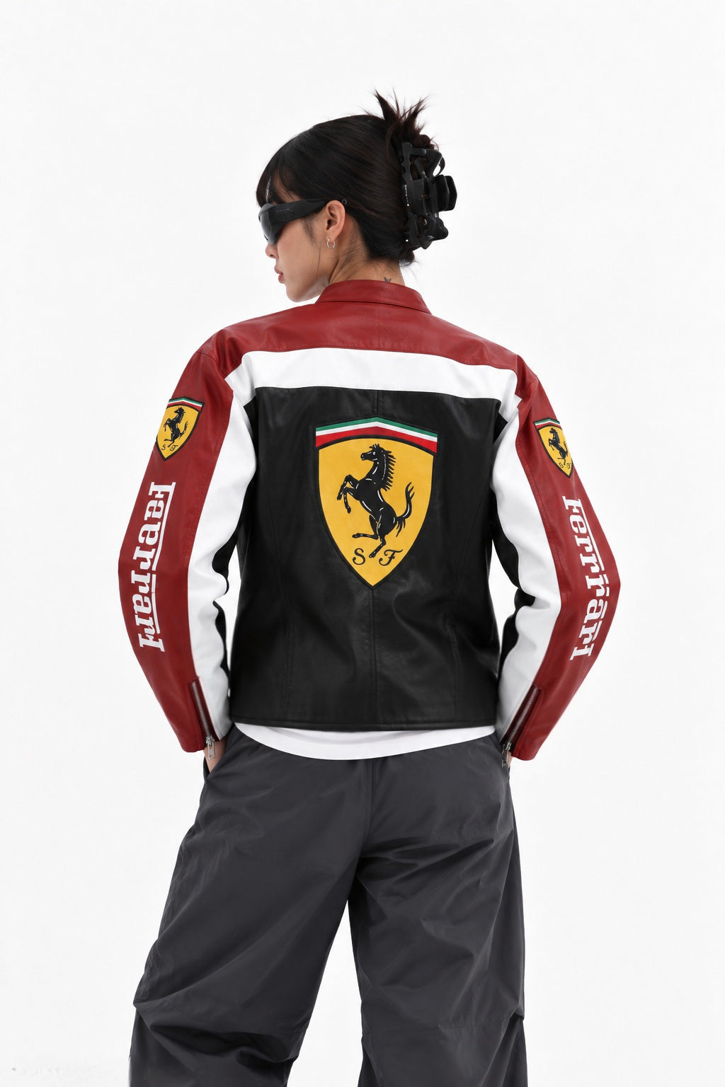 Female model wearing the oversized Formula 1 Ferrari Leather Jacket by Exotix, showcasing the heavy faux leather and Y2K streetwear drape