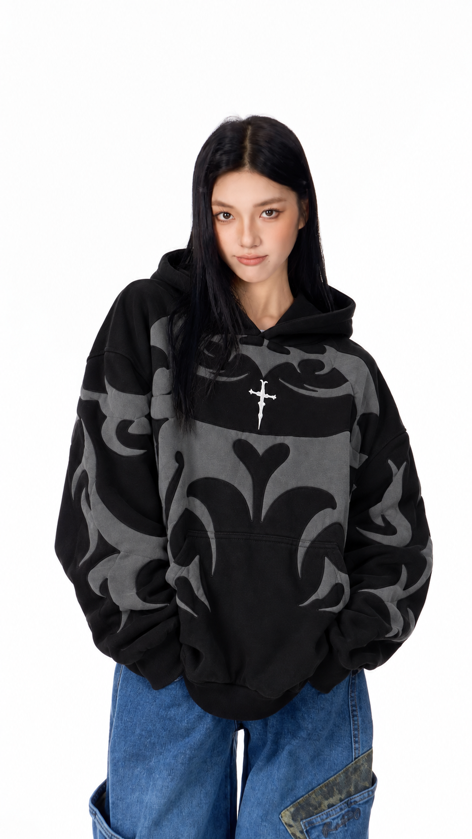 Female model wearing the unisex black Exotix graphic hoodie, showcasing the comfortable drop-shoulder Y2K silhouette
