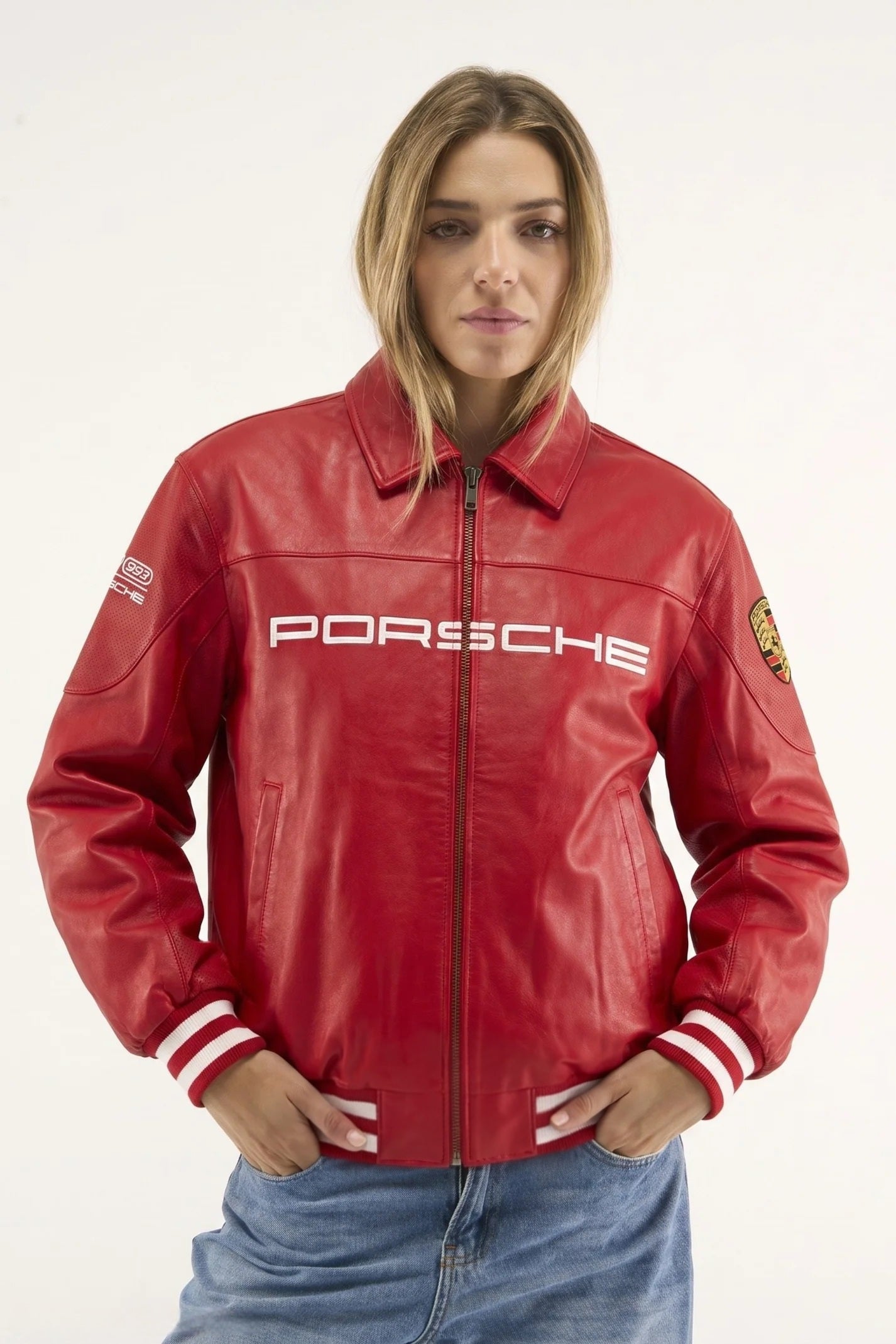 Female model styling the red Porsche leather jacket, highlighting the trendy oversized Y2K paddock-girl aesthetic
