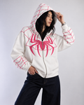Lifestyle shot of the female model in the white Marvel fan apparel, showcasing the thick winter structure and Y2K styling