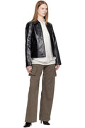 Urban streetwear lifestyle shot highlighting how to style the women's crop leather jacket with high-waisted baggy denim