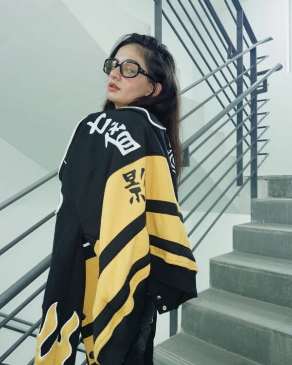 Close-up of Anushka Sen highlighting Naruto-themed symbols and flame patches on the Exotix jacket