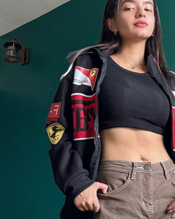 Close-up of black Ferrari bomber jacket showing Scuderia Ferrari and F1 patches – stylish racing team apparel by Exotix