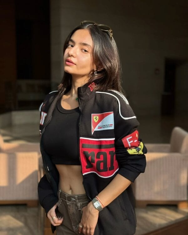 Confident woman in black Ferrari jacket with Scuderia Ferrari logo, styled for streetwear – best price Ferrari jacket by Exotix