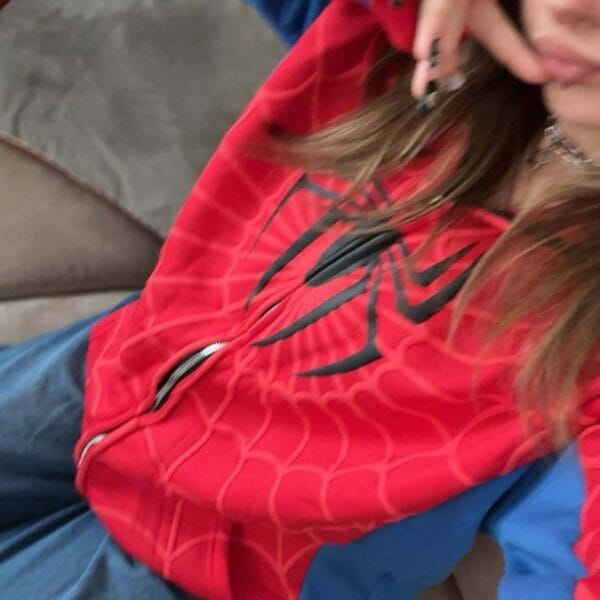 A detailed close-up of the hoodie’s red fabric showing the web design and stitching quality for a premium feel.