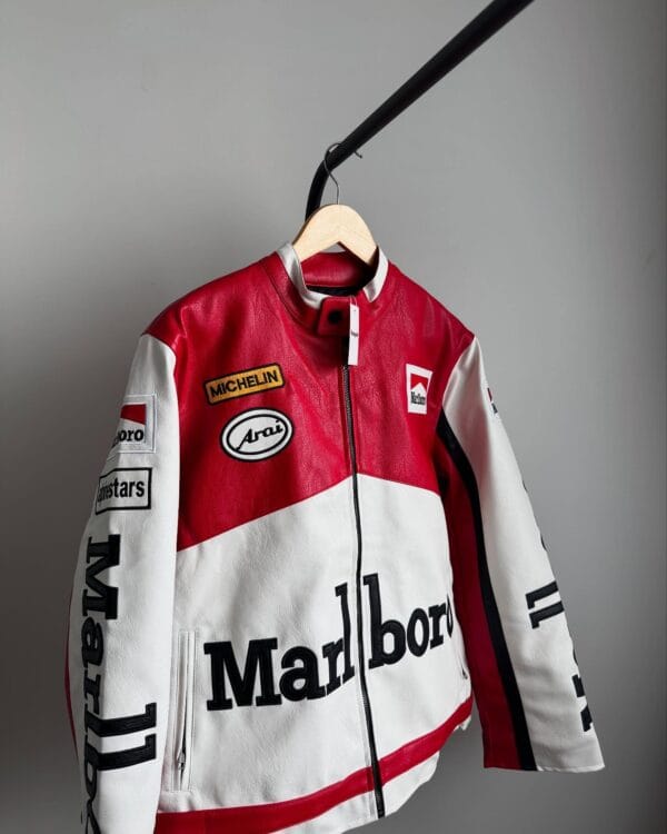 Angled front view of Marlboro leather biker jacket with racing patches and zippered pocket details