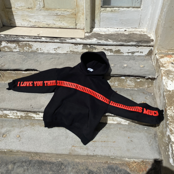 Black I Love You This Much Hoodie laid flat outdoors with bold red print on sleeves – Exotix couple hoodie