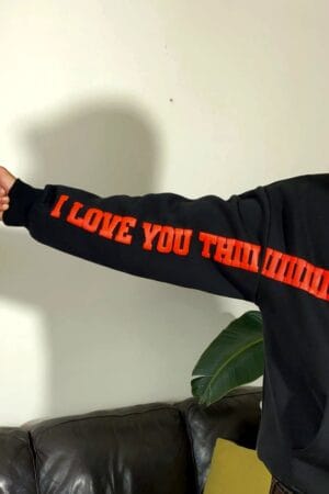 Model showing extended arm with I Love You Thiiiiiiiiiiiiiiiiiiiiiiiiiiiiiiiis Much text printed on hoodie sleeve – Exotix streetwear