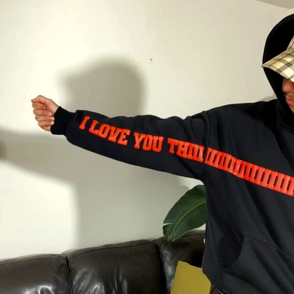 Model showing extended arm with I Love You Thiiiiiiiiiiiiiiiiiiiiiiiiiiiiiiiis Much text printed on hoodie sleeve – Exotix streetwear