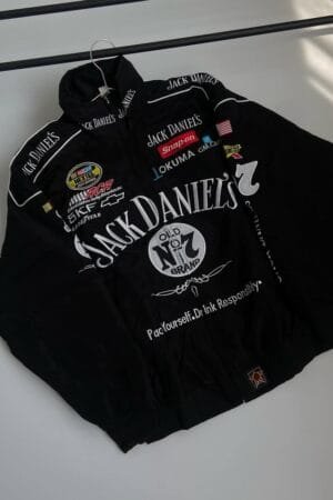 Full front view of black embroidered F1 Jack Daniels racing jacket hanging