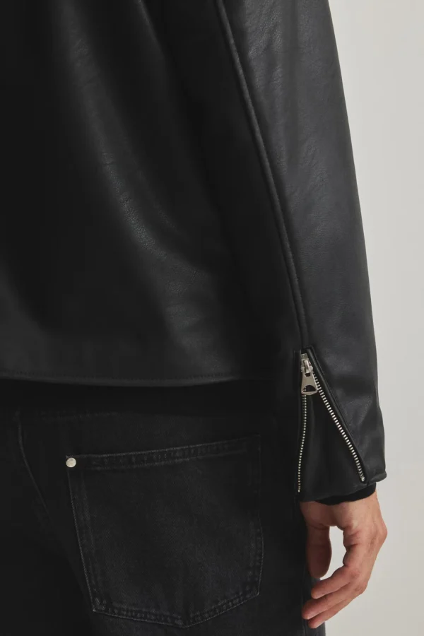 Boxy fit leather jacket cropped length detail showing hem at waist and sleeve zipper - Exotix black jacket