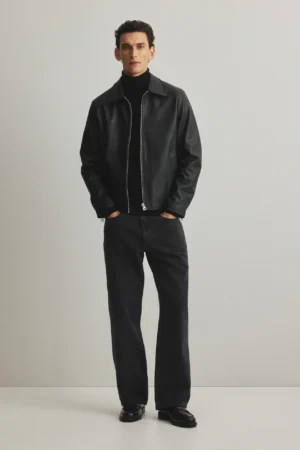 Man wearing black boxy leather jacket with cropped fit paired with turtleneck and jeans - Exotix streetwear style