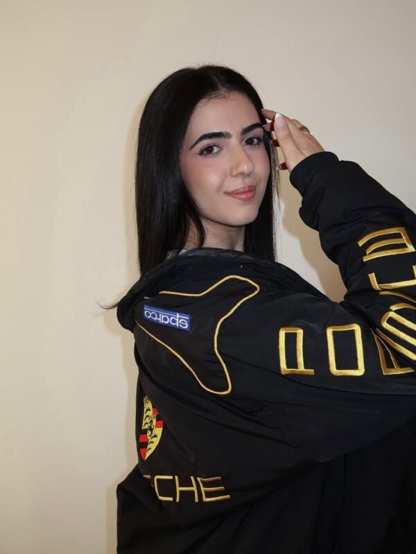 Close-up of Porsche logo embroidery on Exotix bomber jacket for men and women