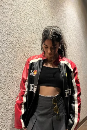 Side angle view of Ferrari racing leather jacket highlighting red, black and white panels