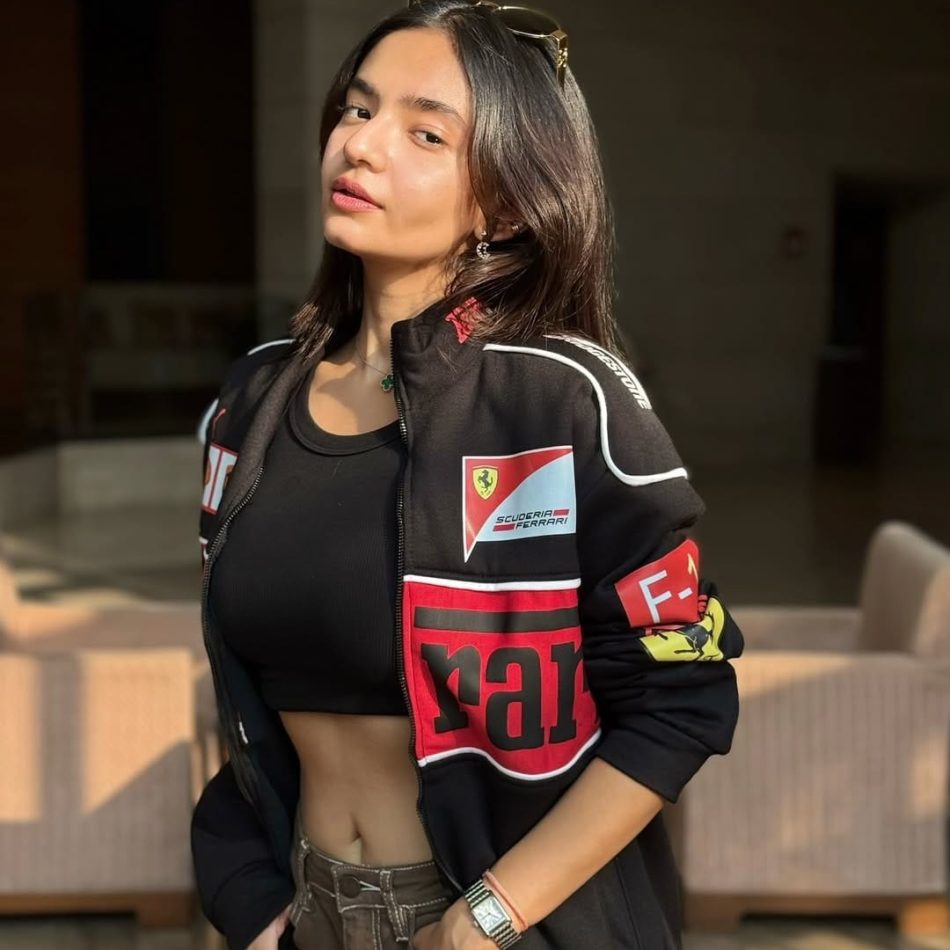 How to Style a Black Ferrari Jacket Like Celebrities in 2025 (With Fabric & Fit Tips) Confident woman in black Ferrari jacket with Scuderia Ferrari logo, styled for streetwear – best price Ferrari jacket by Exotix