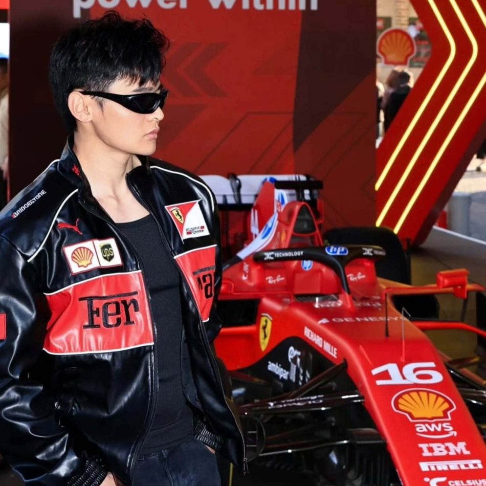 How to Style a Black Ferrari Jacket Like Celebrities in 2025 (With Fabric & Fit Tips) Man wearing Ferrari racing jacket standing in front of F1 race car – Exotix limited edition
